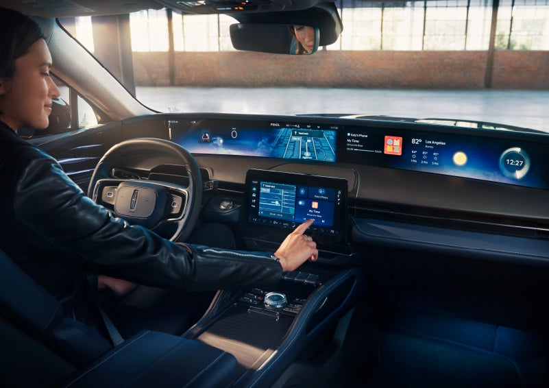 The driver of a 2024 Lincoln Nautilus® SUV interacts with the center touchscreen. | Joe Cooper Lincoln of Edmond in Oklahoma City OK